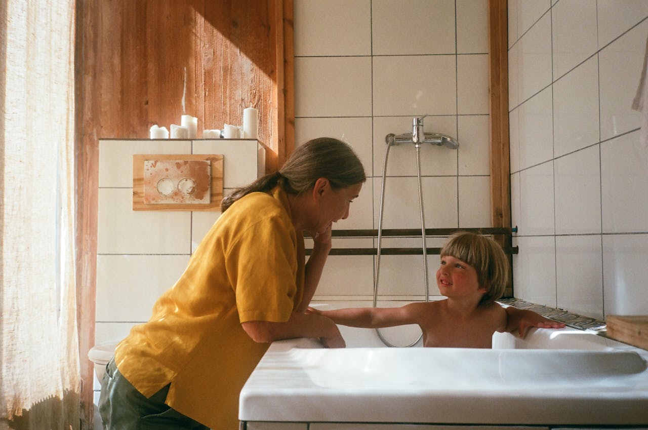 about-us A warm moment between a grandmother and grandchild during bath time in a cozy bathroom.